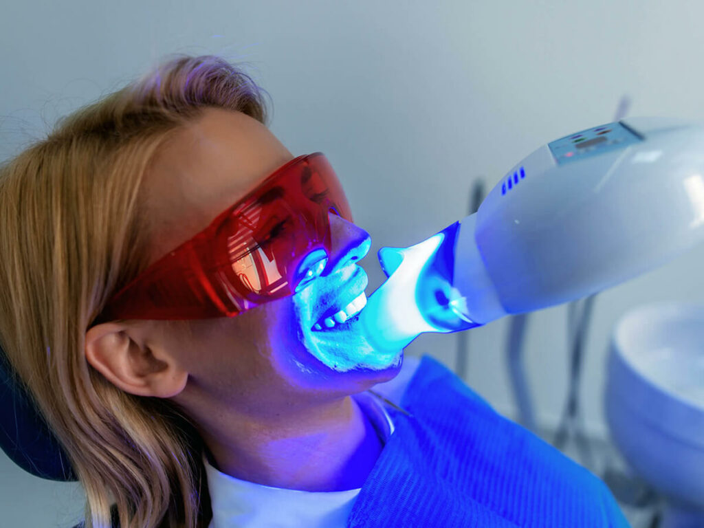 A woman getting professional in-office teeth whitening