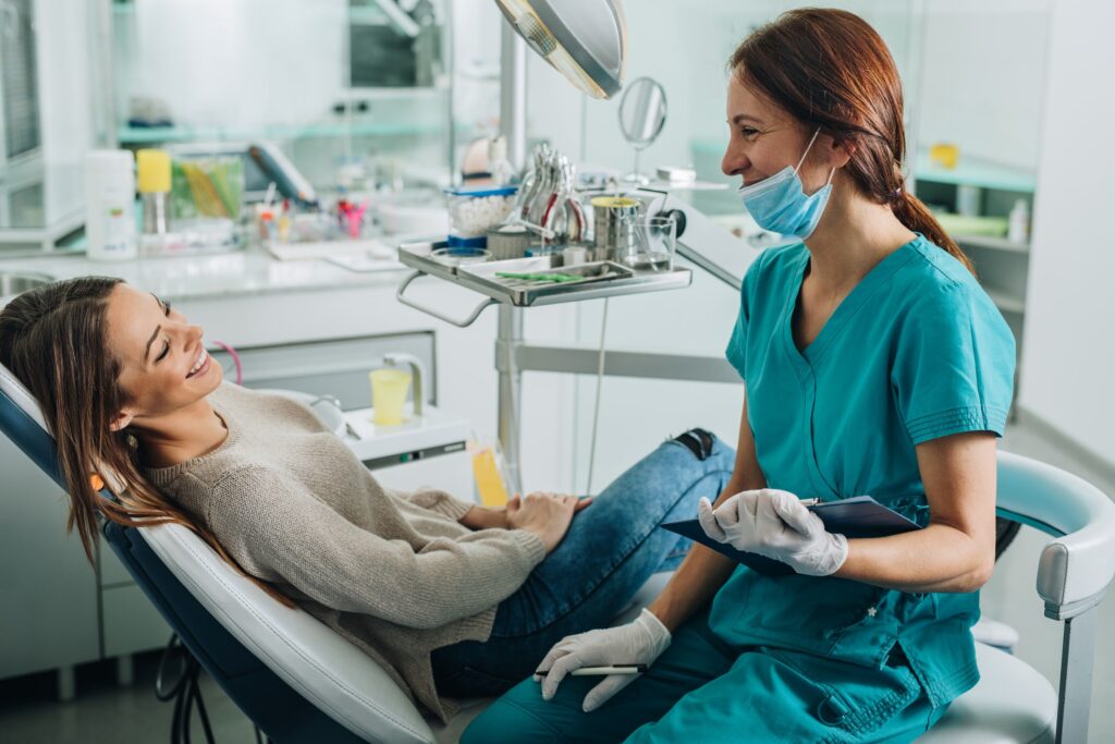 dental hygienist laughing with a patient