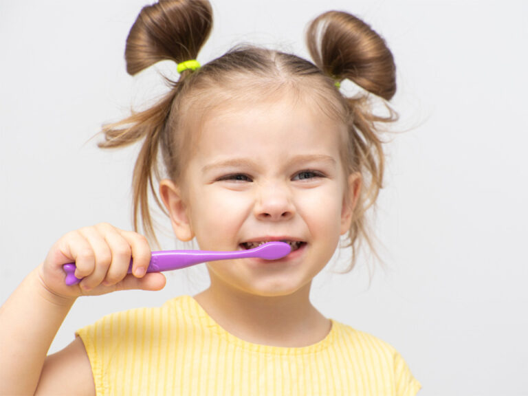 little girl brushing her teeth